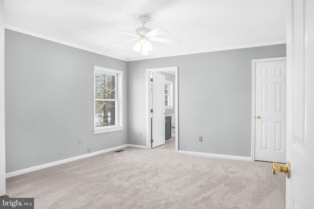 unfurnished bedroom with light carpet, ornamental molding, ceiling fan, and ensuite bathroom