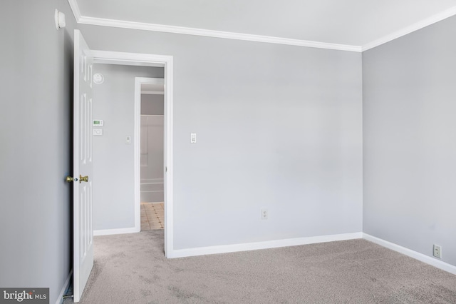 carpeted spare room with crown molding