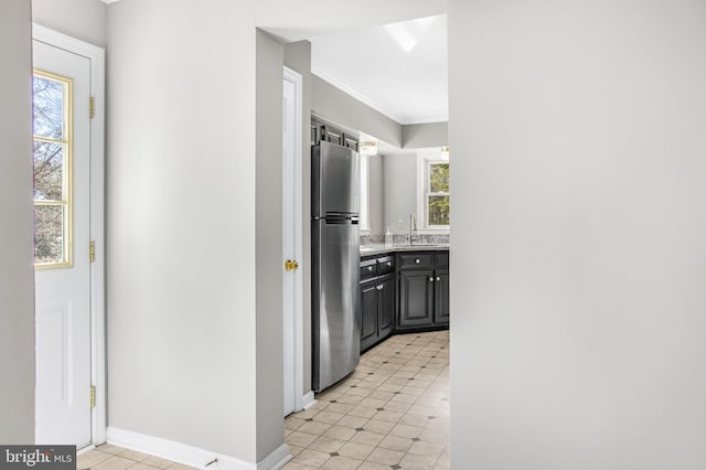 hallway featuring crown molding, a healthy amount of sunlight, and sink