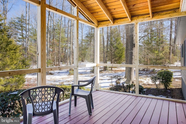unfurnished sunroom with vaulted ceiling with beams and wood ceiling