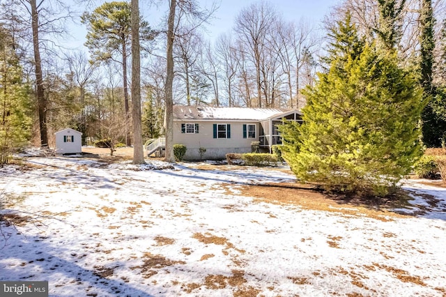 view of front of home with a shed