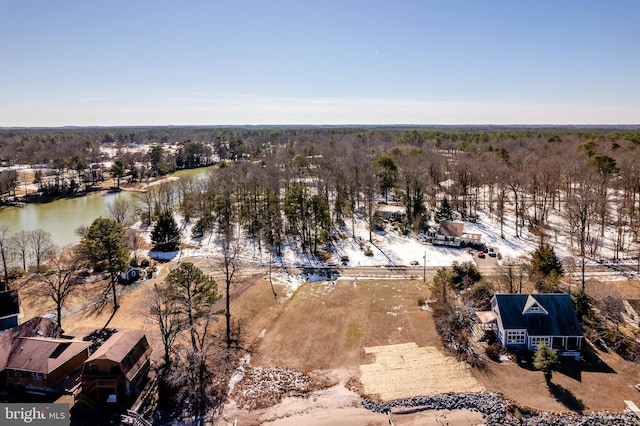 snowy aerial view with a water view