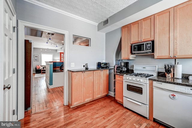 kitchen with white appliances, light hardwood / wood-style flooring, track lighting, dark stone counters, and light brown cabinets