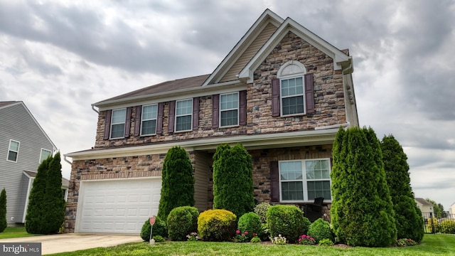 view of front of home with a garage and a front lawn