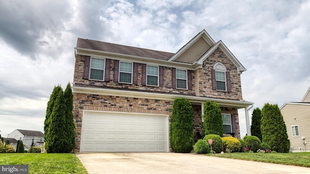 view of front of property with a garage and a front lawn