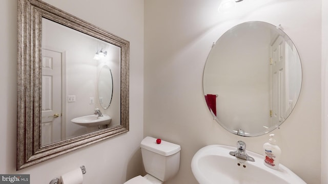 bathroom featuring sink and toilet