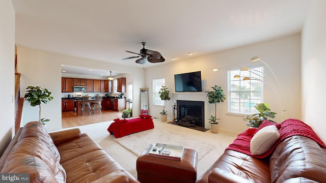 living room with ceiling fan and light wood-type flooring