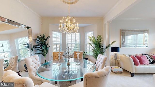 carpeted dining space with a notable chandelier, crown molding, and ornate columns