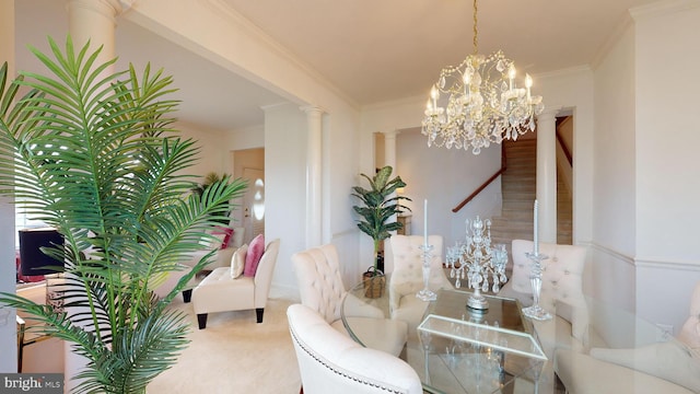 dining room with a notable chandelier, crown molding, decorative columns, and carpet