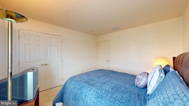 carpeted bedroom with a closet