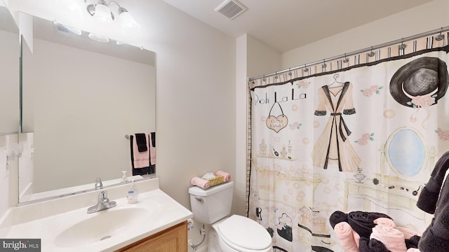 bathroom featuring vanity, toilet, and a shower with shower curtain