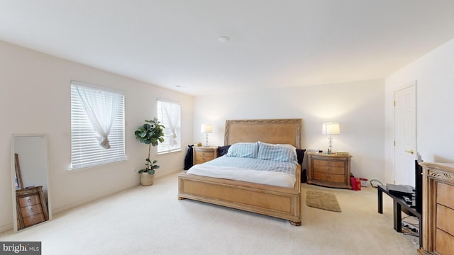 bedroom featuring light colored carpet