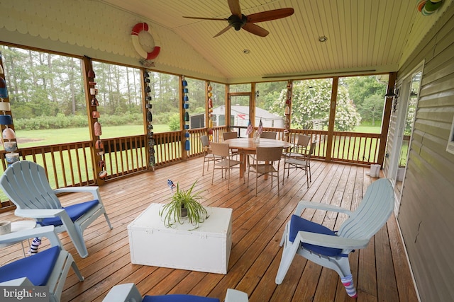 sunroom / solarium with lofted ceiling, a wealth of natural light, and ceiling fan