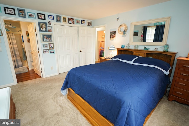 carpeted bedroom with a closet and connected bathroom