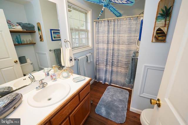 bathroom featuring toilet, hardwood / wood-style floors, and vanity