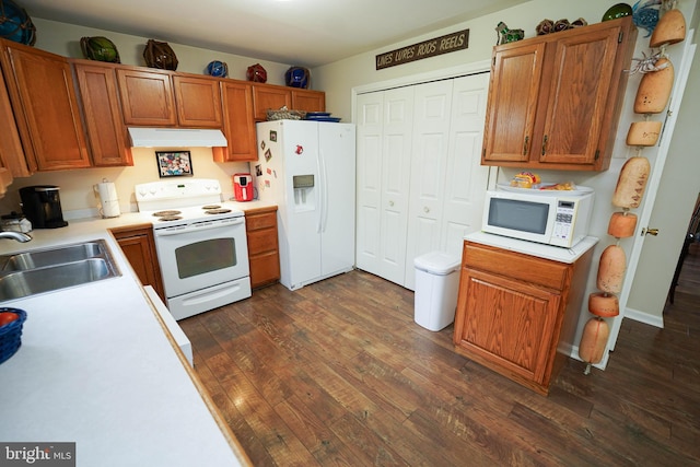 kitchen with sink, dark hardwood / wood-style flooring, and white appliances