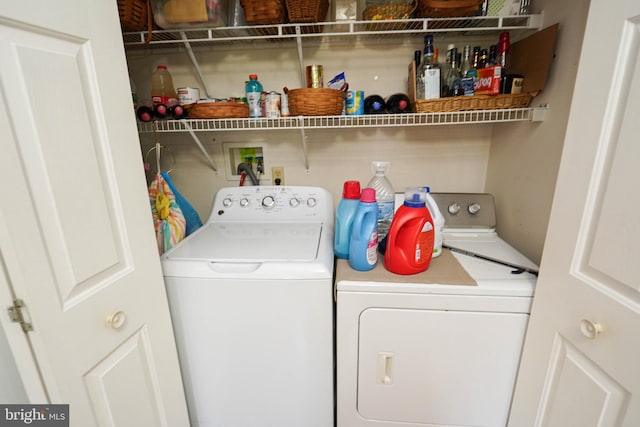 clothes washing area with washing machine and dryer