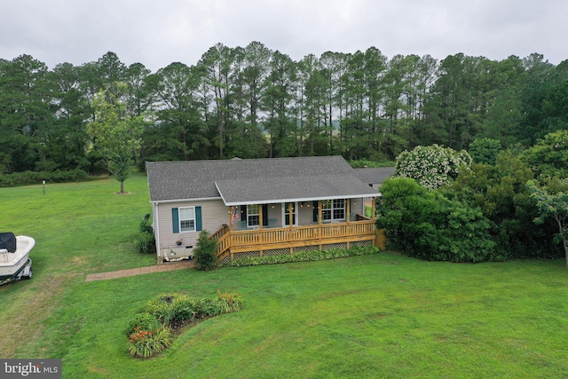 ranch-style home with a wooden deck and a front yard