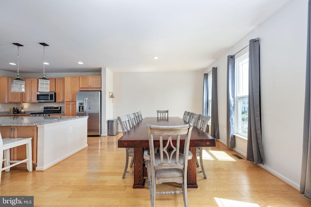 dining room with light wood-style floors, visible vents, baseboards, and recessed lighting