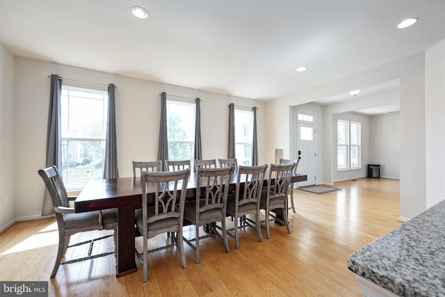 dining area with baseboards, light wood-style flooring, and recessed lighting