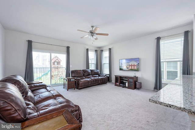 living area featuring ceiling fan and light colored carpet