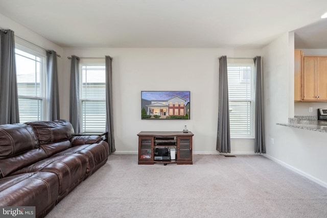 living room with light carpet and baseboards