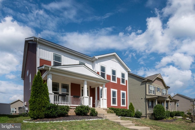 traditional-style home with a front lawn, a porch, and board and batten siding