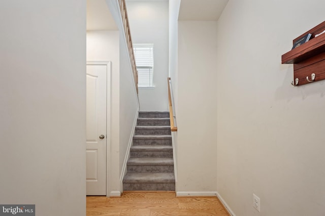 stairway featuring baseboards and wood finished floors