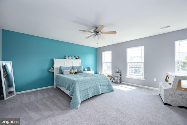 bedroom featuring carpet floors, baseboards, visible vents, and ceiling fan