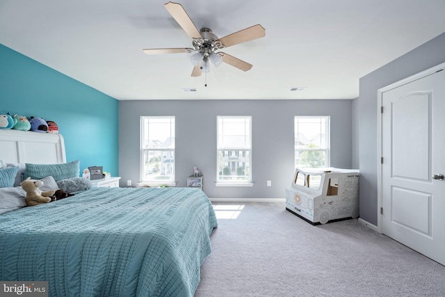 bedroom with light carpet, multiple windows, and visible vents