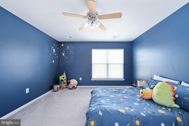 carpeted bedroom featuring ceiling fan, visible vents, and baseboards