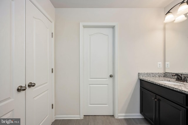 bathroom with baseboards and vanity