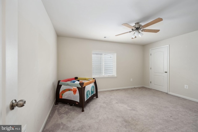 bedroom with baseboards, ceiling fan, visible vents, and light colored carpet