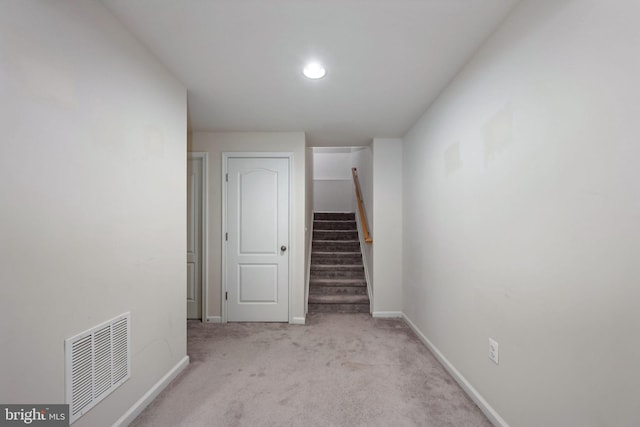 stairs with carpet, visible vents, and baseboards