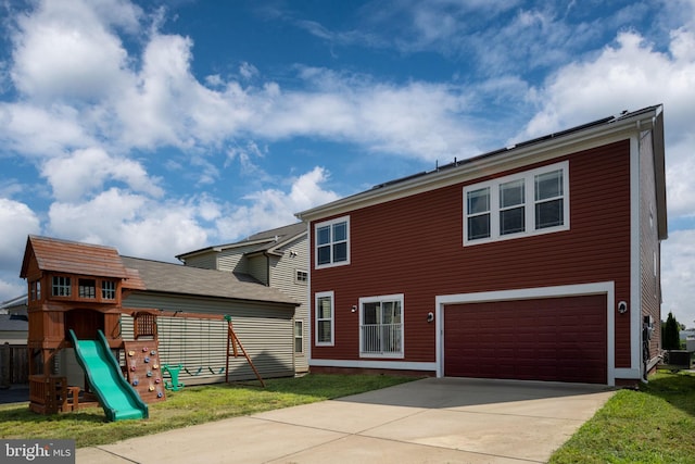 view of front facade featuring a garage, a playground, and driveway