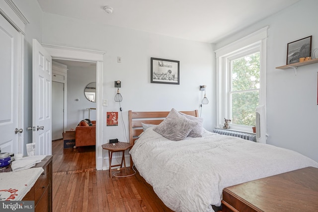 bedroom with dark hardwood / wood-style floors