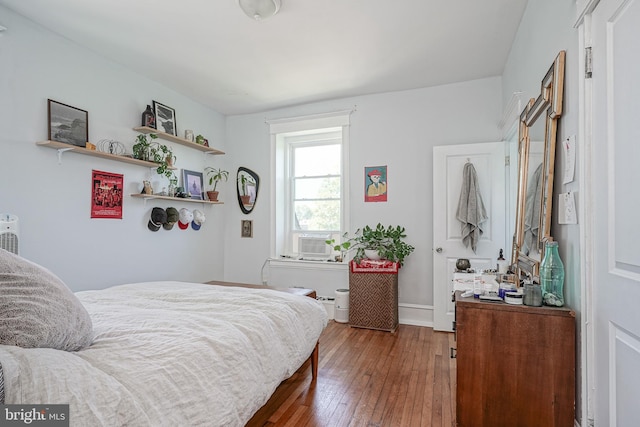 bedroom featuring hardwood / wood-style floors and cooling unit