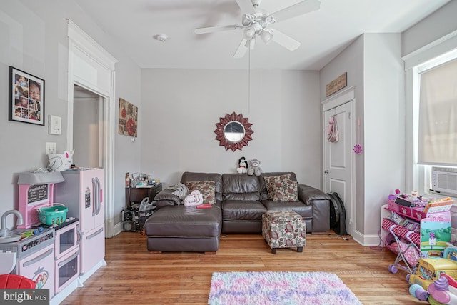 living room featuring light hardwood / wood-style floors and ceiling fan