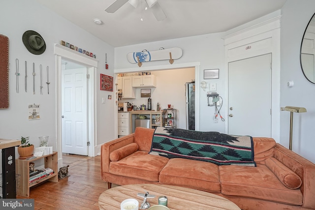 living room with light hardwood / wood-style floors and ceiling fan