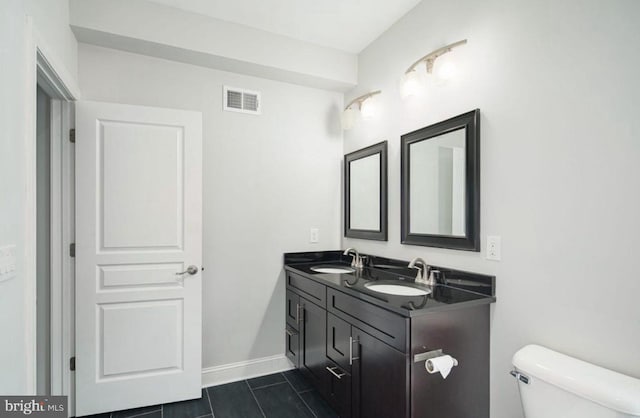 bathroom featuring tile patterned floors, vanity, and toilet