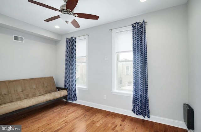 living area featuring ceiling fan and hardwood / wood-style floors