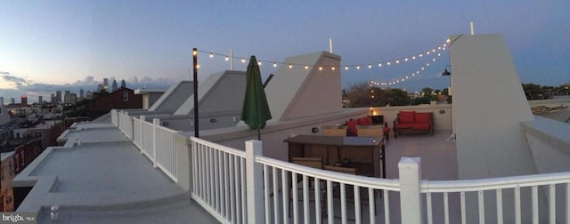 property exterior at dusk with a balcony