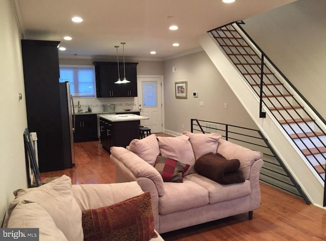 living room featuring wood-type flooring and ornamental molding