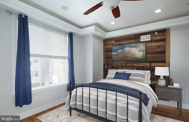 bedroom with ornamental molding, hardwood / wood-style floors, and ceiling fan