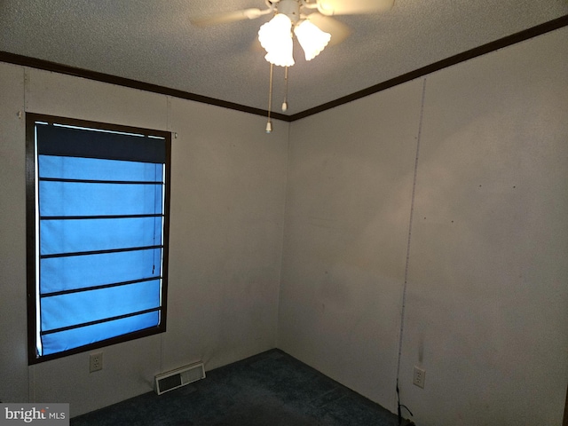 unfurnished room with carpet flooring, ceiling fan, crown molding, and a textured ceiling