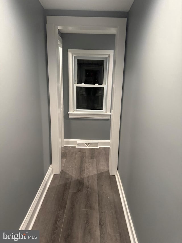 hallway with dark hardwood / wood-style floors