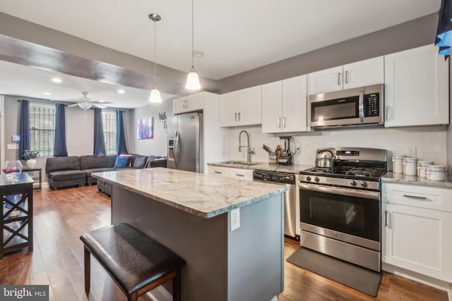 3220 Elmley Ave, Baltimore, MD 21213 - kitchen featuring a kitchen island, white cabinetry, appliances with stainless steel finishes, and sink