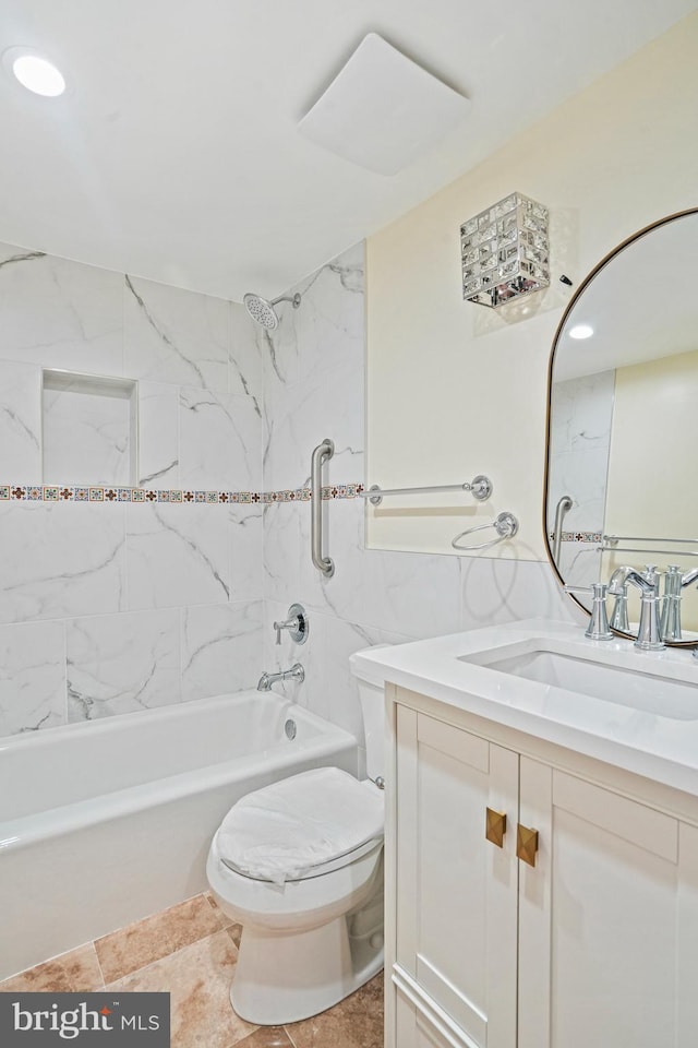 full bathroom featuring vanity, tiled shower / bath, and toilet