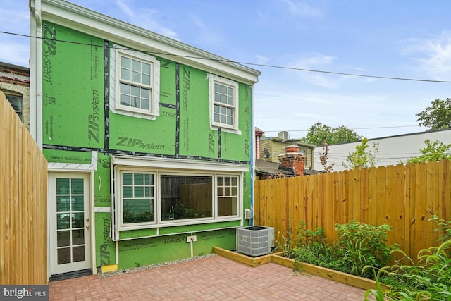 view of side of home featuring a patio and central air condition unit