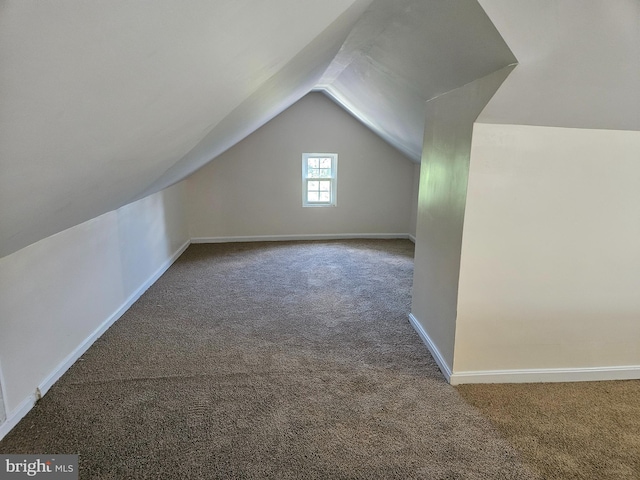 bonus room featuring lofted ceiling and carpet flooring